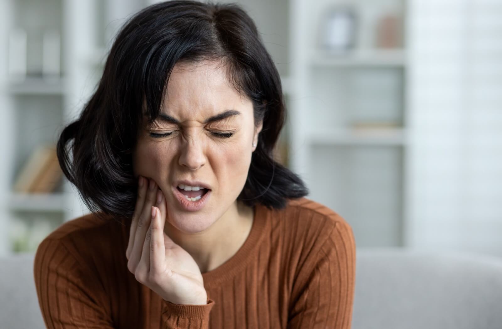 A patient experiencing pain before a root canal procedure.