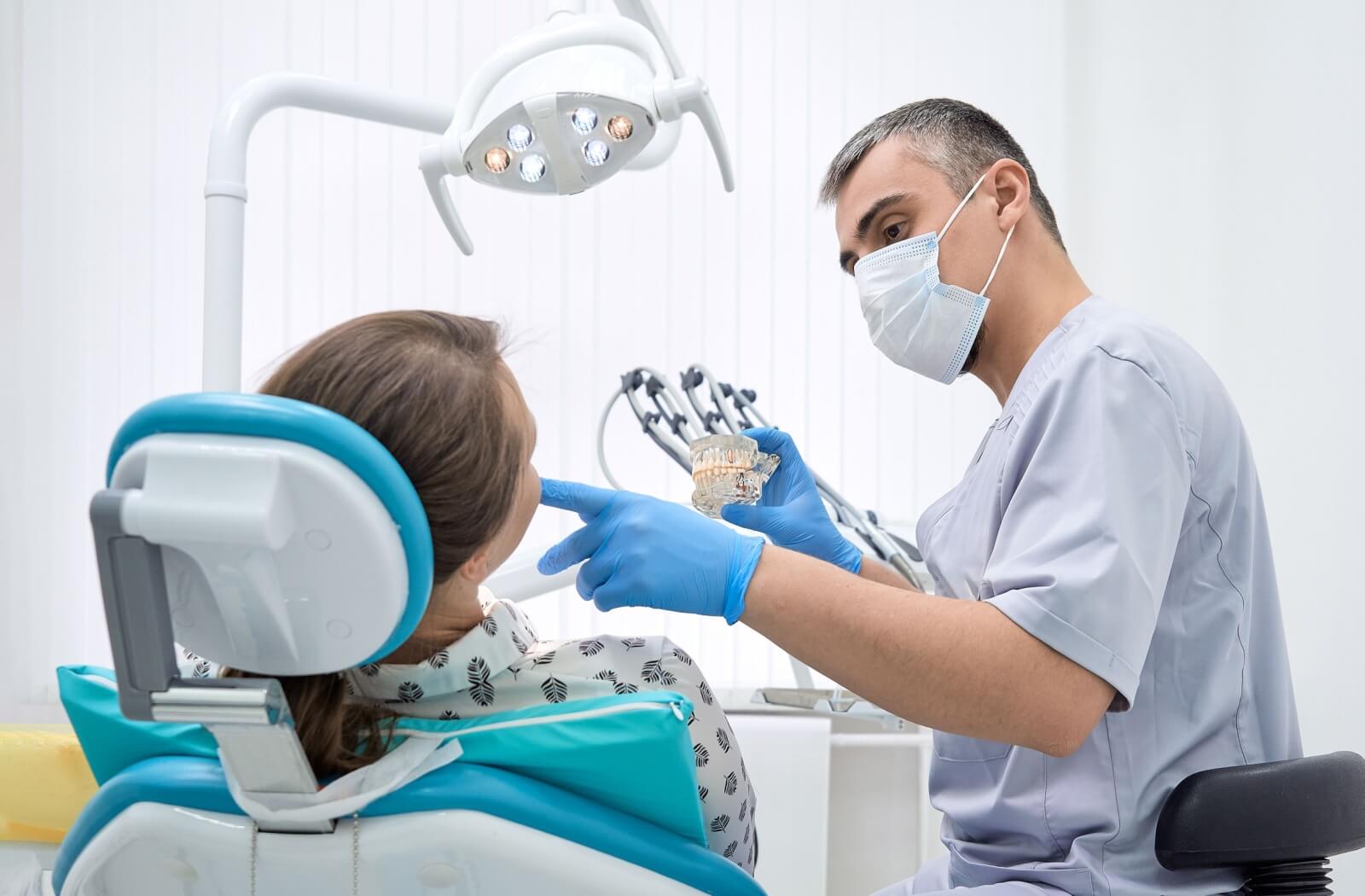 A patient discusses with their dentist about their Guided Biofilm Therapy.