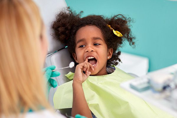 A young girl at a pediatric dental exam in Hamilton, Ontario.
