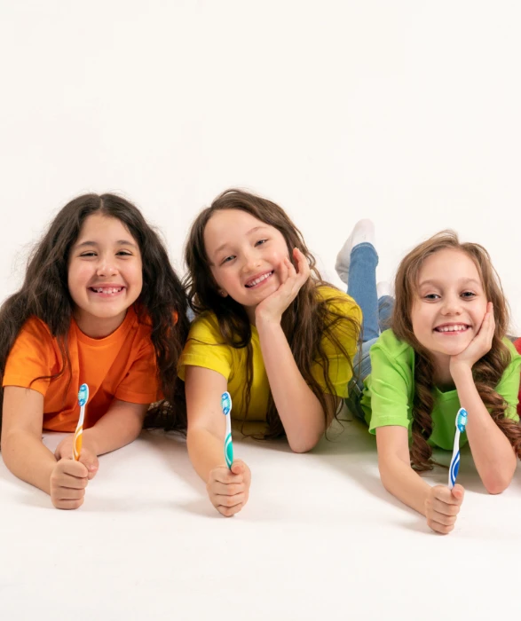 group of children holding toothbrushes
